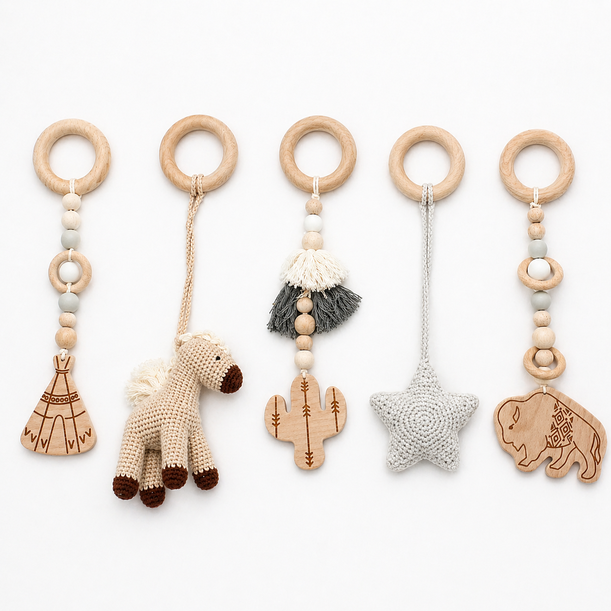 Set of five wooden baby teething rings with various charms on a white background